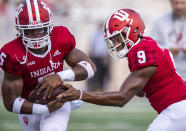Indiana quarterback Michael Penix Jr. (9) hands off to running back Stephen Carr (5) as the team warms up before an NCAA college football game against Idaho, Saturday, Sept. 11, 2021, in Bloomington, Ind. (AP Photo/Doug McSchooler)