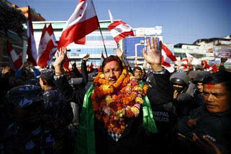 Rajan K.C. (C), candidate of party Nepali Congress, waves at his supporters after defeating Chairman of the Unified Communist Party of Nepal (Maoist) Pushpa Kamal Dahal, also known as Prachanda, from election constituency number 10, in Kathmandu November 21, 2013. REUTERS/Navesh Chitrakar