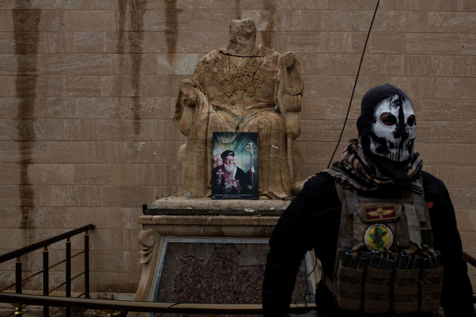 An Iraqi Army Special forces soldier guards a church in Bartella, Iraq