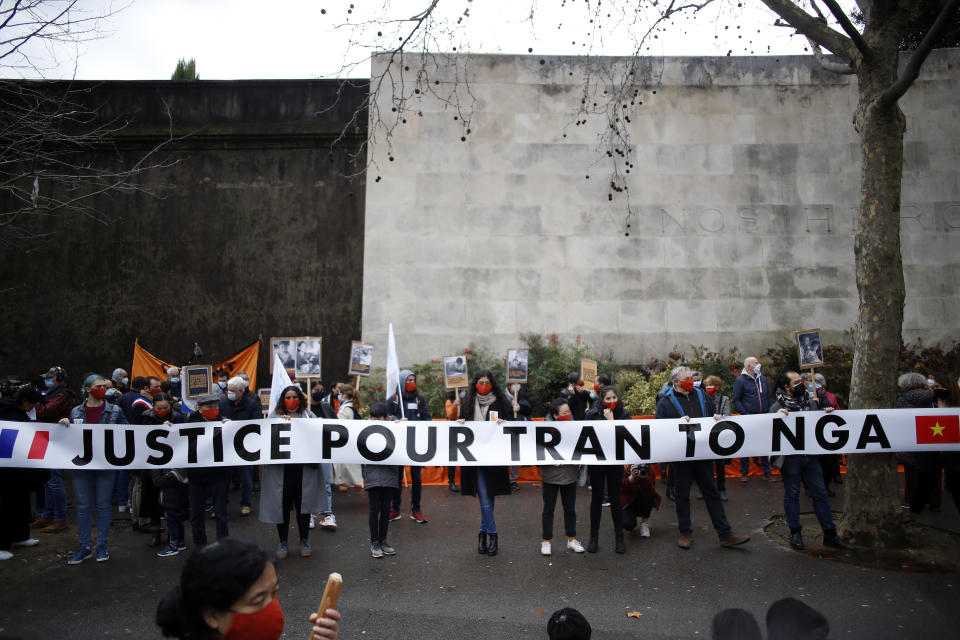 Activists hold a banner reading « Justice for Tran To Nga » during a gathering in support of people exposed to Agent Orange during the Vietnam War, in Paris, Saturday Jan. 30, 2021. Activists gathered Saturday in Paris in support of people exposed to Agent Orange during the Vietnam War, after a French court examined a case opposing a French-Vietnamese woman to 14 companies that produced and sold the toxic chemical. (AP Photo/Thibault Camus)