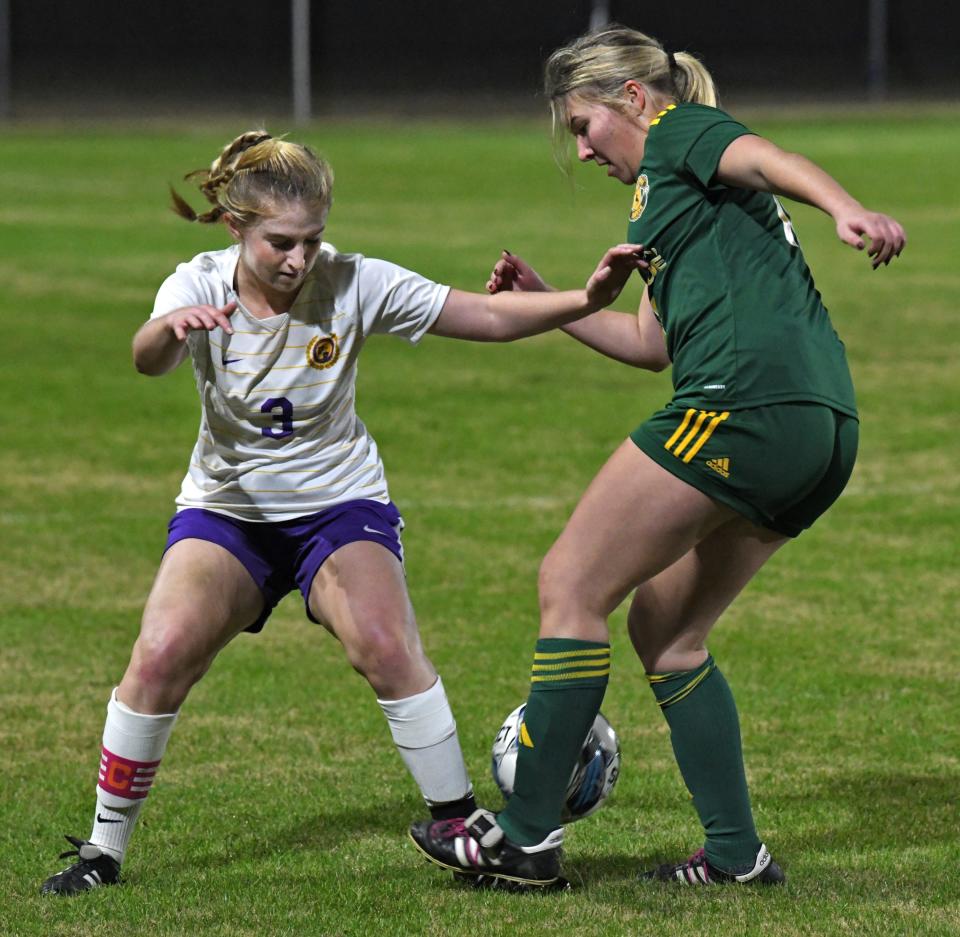 Byrd's Lily Blaylock fights for control of the ball against Captain Shreve in a soccer game Tuesday 12-05-23.