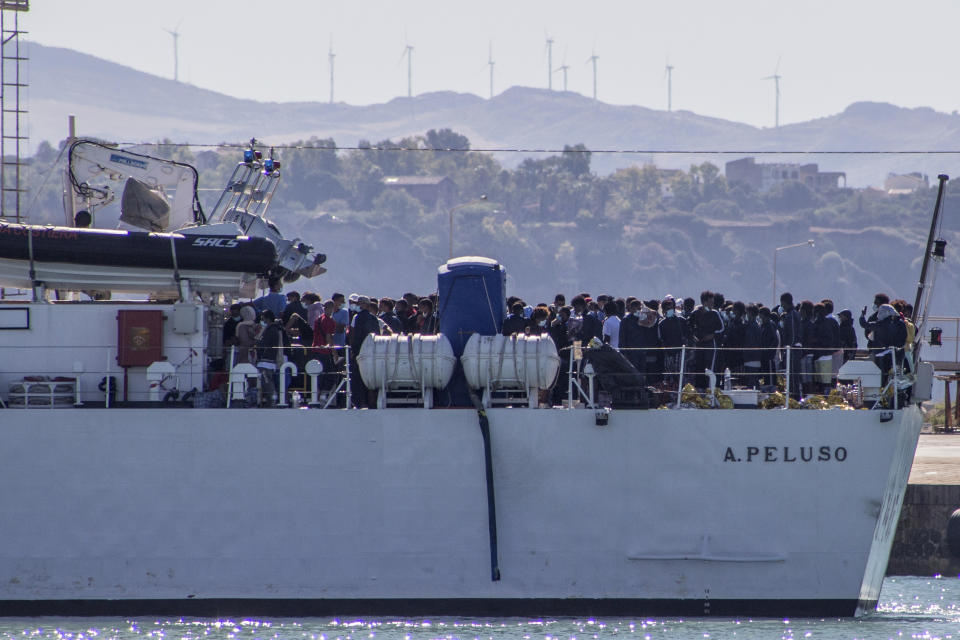 Migrants arrive in Porto Empedocle, Sicily, aboard two military ships after being transferred from the island of Lampedusa, where a number of small boat carrying migrants arrived in the last days, Monday, July 27, 2020. (Fabio Peonia/LaPresse via AP)