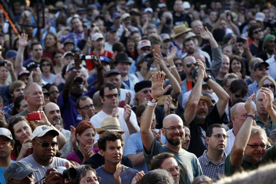 People in the crowd cheer at a sunrise concert marking International Jazz Day in New Orleans, Monday, April 30, 2012. The performance, at Congo Square near the French Quarter, is one of two in the United States that day; the other is in the evening in New York. Thousands of people across the globe are expected to participate in International Jazz Day, including events in Belgium, France, Brazil, Algeria and Russia. (AP Photo/Gerald Herbert)