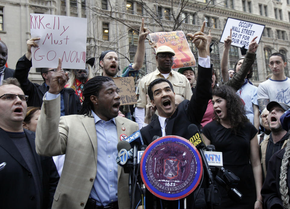New York City Council members Jumaane Williams, second left, and Ydanis Rodriguez, center, join Occupy Wall Street protesters to denounce what they say is the NYPD's excessive use of force against demonstrators, in New York's Zuccotti Park, Monday, March 19, 2012. Police arrested 73 people on Saturday after hundreds of activists had gathered to mark the sixth-month birthday of the movement. (AP Photo/Richard Drew)
