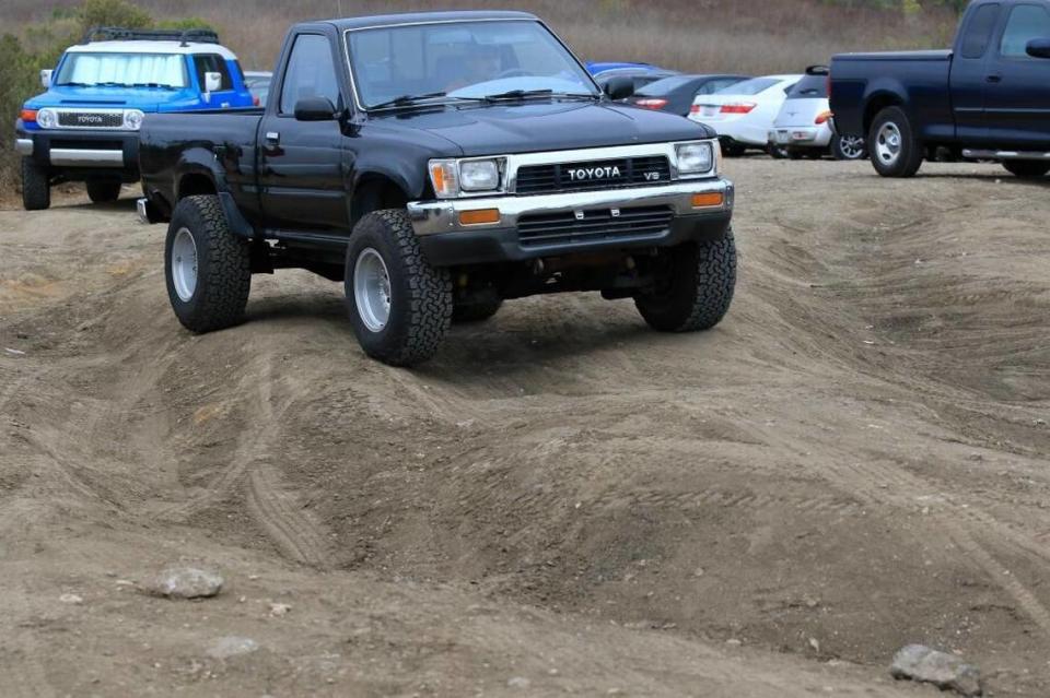 A pickup truck navigates the rutted dirt lot at Pirate’s Cove in 2019.