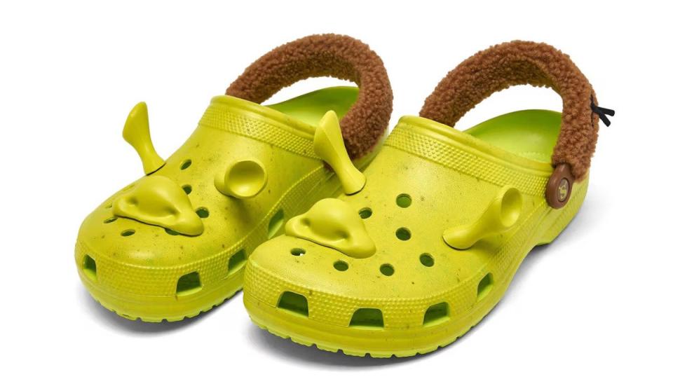 An image of two Shrek Crocs that are bright green with brown straps