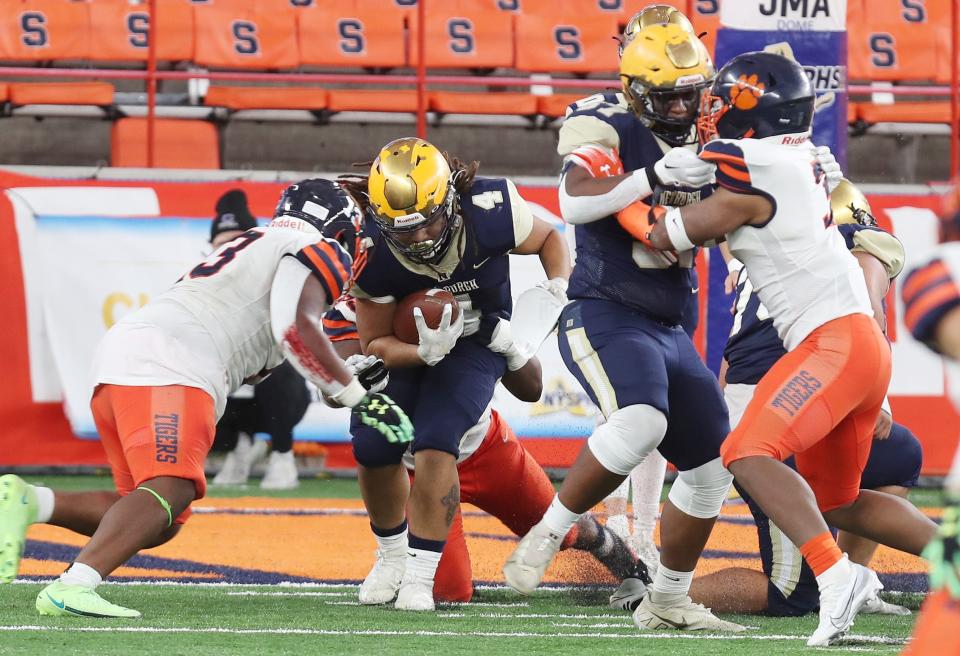 Newburgh's Tajir Walker (4) looks for some running room in the Bennett defense during the state Class AA football championship at JMA Wireless Dome in Syracuse Dec. 4, 2022. 