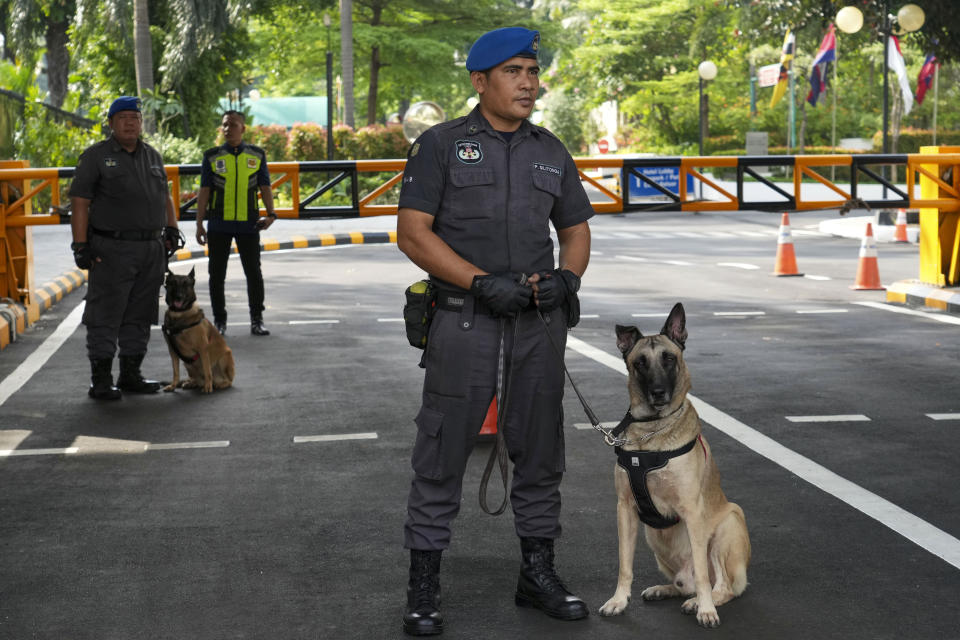Indonesian security officers with their dogs stand guard ahead of the Association of Southeast Asian Nations (ASEAN) foreign ministers' meeting in Jakarta, Indonesia, Monday, July 10, 2023. Southeast Asia’s top diplomats gather for talks this week in Indonesia. (AP Photo/Tatan Syuflana)