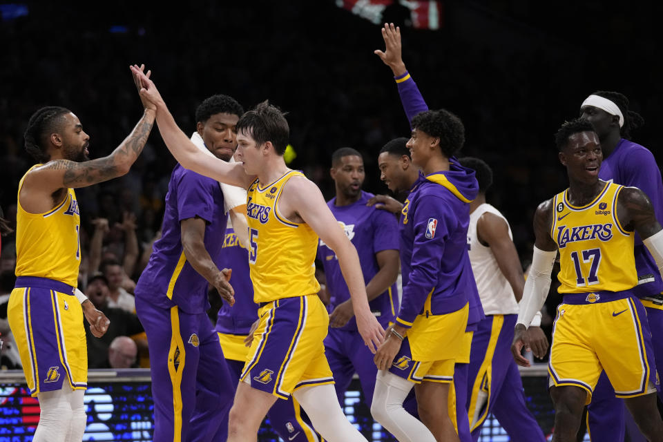 Los Angeles Lakers guard Austin Reaves, third from left, is high-fived after making a 3-point basket at the buzzer at the end of the first half in Game 6 of an NBA basketball Western Conference semifinal series Friday, May 12, 2023, in Los Angeles. (AP Photo/Ashley Landis)