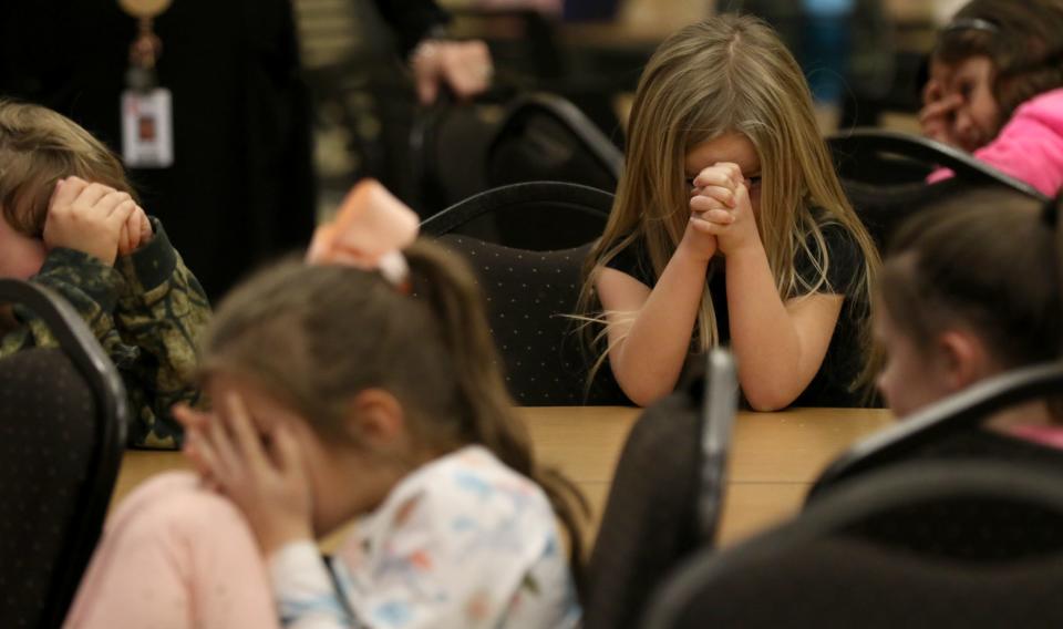 Students pray during chapel time at the Shelby campus of Gaston Christian School Thursday morning, Feb. 2, 2023.