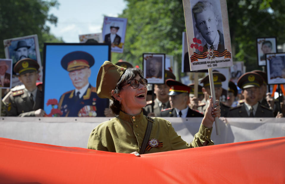 People carry portraits of relatives who fought in World War II, during the Immortal Regiment march in Bishkek, Kyrgyzstan, Monday, May, 9, 2022, marking the 77th anniversary of the end of World War II. (AP Photo/Vladimir Voronin)