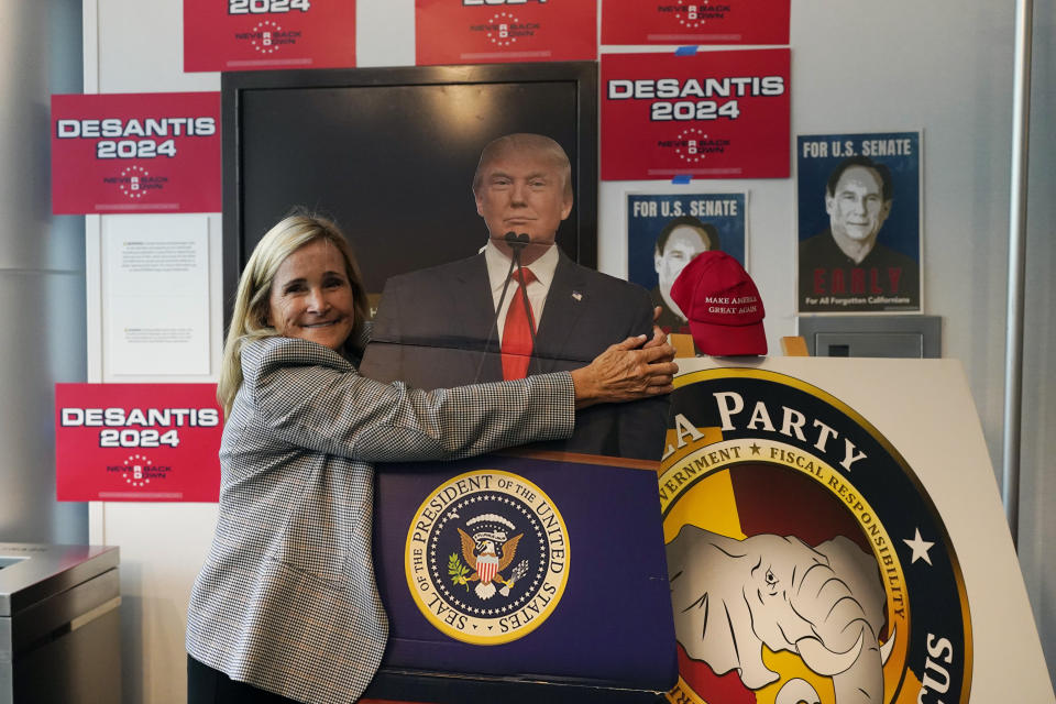 A supporter of Former President Donald Trump hugs a cardboard cutout with his likeness before Trump's keynote speech at the California Republican Party Convention Friday, Sept. 29, 2023, in Anaheim, Calif. (AP Photo/Jae C. Hong)