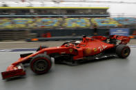Ferrari driver Sebastian Vettel of Germany steers his car back to his garage during the first practice session at the Marina Bay City Circuit ahead of the Singapore Formula One Grand Prix in Singapore, Friday, Sept. 20, 2019. (AP Photo/Vincent Thian)