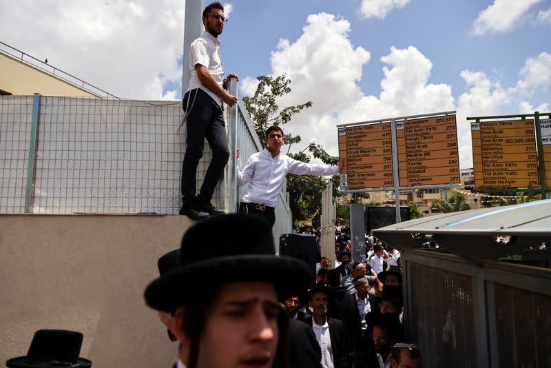 Israelis take part in the funeral service of Yonatan Havakuk and Boaz Gol who were killed in what police said was a Palestinian attack, on the country's independence day, in Elad