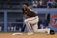 San Diego Padres' Jurickson Profar winces after injuring himself while trying to steal second during the fourth inning of a baseball game against the Los Angeles Dodgers Wednesday, Sept. 29, 2021, in Los Angeles. Profar was tagged out on the play. (AP Photo/Mark J. Terrill)