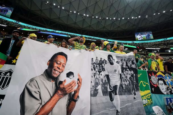 PHOTO: Supporters of Brazil pose for a photo with a banner of Pele prior to the match between Brazil and Cameroon at the FIFA World Cup, on Dec. 2, 2022, in Lusail, Qatar.  (Florencia Tan Jun/SPP via Shutterstock )