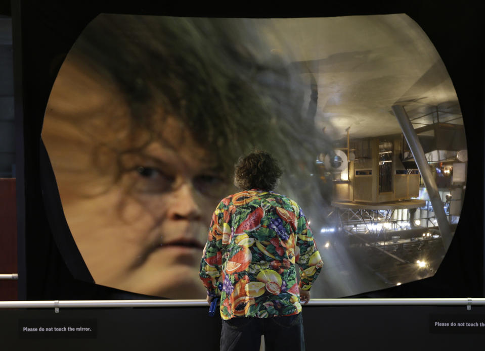 Richard Brown sees a reflection of himself while looking into the giant mirror at the Exploratorium, an interactive science and activities museum, during a preview in San Francisco, Tuesday, April 9, 2013. The new $300 million museum is set to open April 17 at its new location along the bay with more space and new exhibits. The 330,000-square-foot museum at Pier 15 along the Embarcadero has three times more space than the previous location at the Palace of Fine Arts in the city's Marina neighborhood. (AP Photo/Eric Risberg)