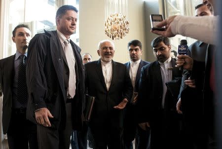 Iranian Foreign Minister Javad Zarif is greeted by the Iranian media outside a restaurant at the Beau Rivage Palace Hotel on March 27, 2015 in Lausanne. REUTERS/Brendan Smialowski/Pool