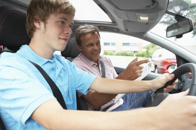 teenage boy taking a driving...