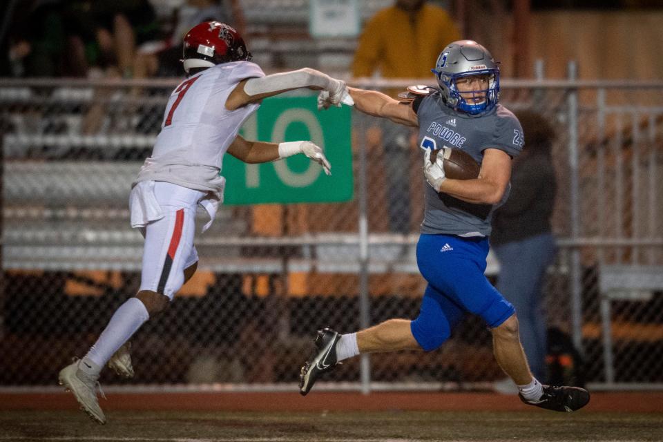 Poudre High School football player Saje Camirand breaks a tackle by Fairview's Bryce Wanjau on his way to the end zone on a touchdown run Thursday night. Fairview won the game 33-31 at French Field in Fort Collins.