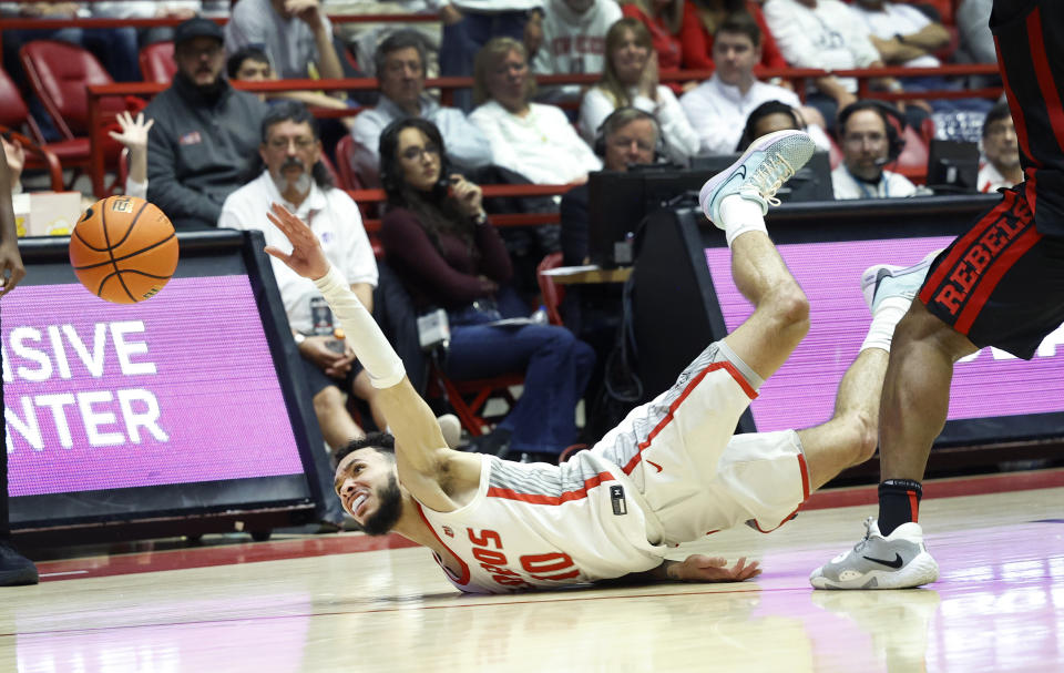 New Mexico guard Jaelen House hits the floor while losing control of the ball during the second half of an NCAA college basketball game against UNLV, Saturday, Feb. 10, 2024, in Albuquerque, N.M. UNLV won 80-77. (AP Photo/Eric Draper)