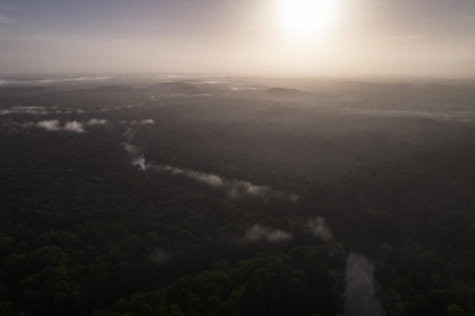 An aerial view of the winding Barama River during sunrise in Chinese Landing, Guyana, Monday, April 17, 2023. Chinese Landing secured its land title in 1976. (AP Photo/Matias Delacroix)