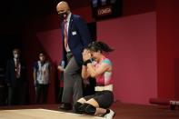 Kuo Hsing-Chun of Taiwan celebrates after winning the gold medal in the women's 59kg weightlifting event, at the 2020 Summer Olympics, Tuesday, July 27, 2021, in Tokyo, Japan. She won gold medal and sets a new Olympic record. (AP Photo/Luca Bruno)