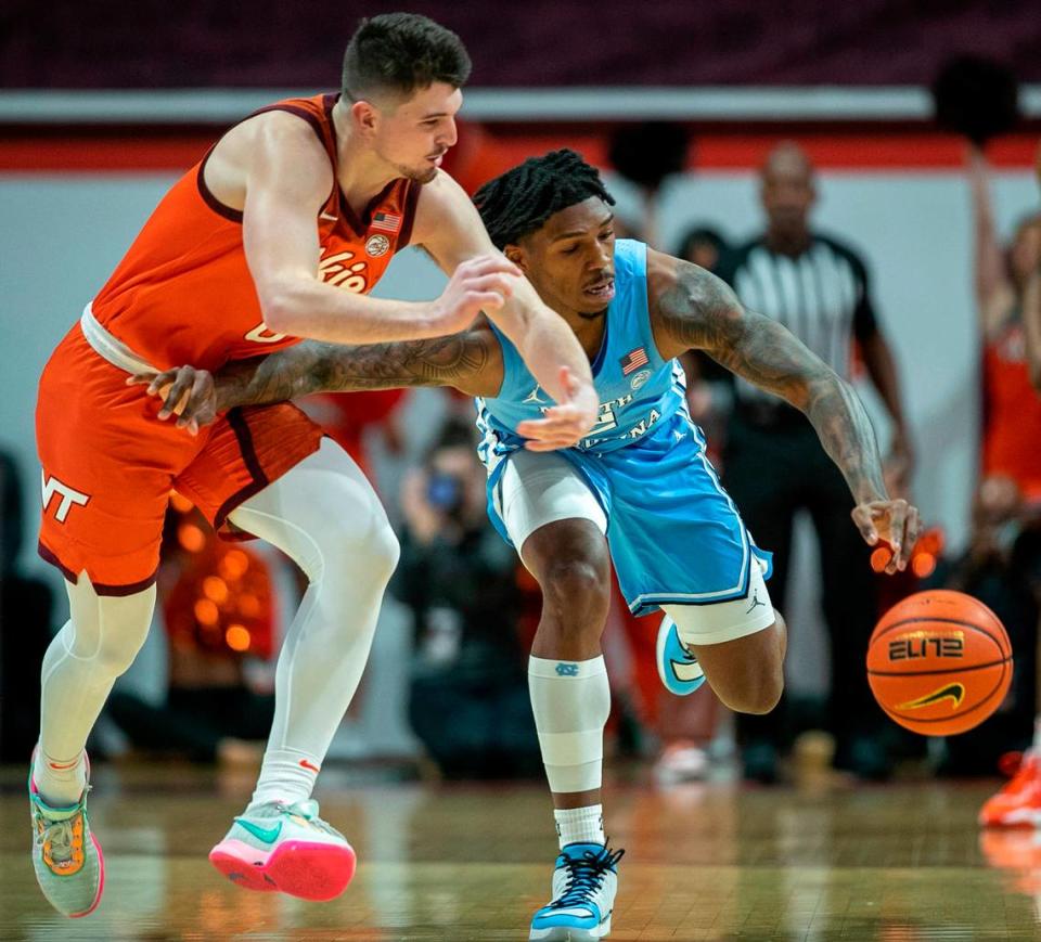 North Carolina’s Caleb Love (2) makes a steal from Virginia Tech’s Hunter Cattoor (0) during the first half on Sunday, December 4, 2022 at Cassell Coliseum in Blacksburg, Va.