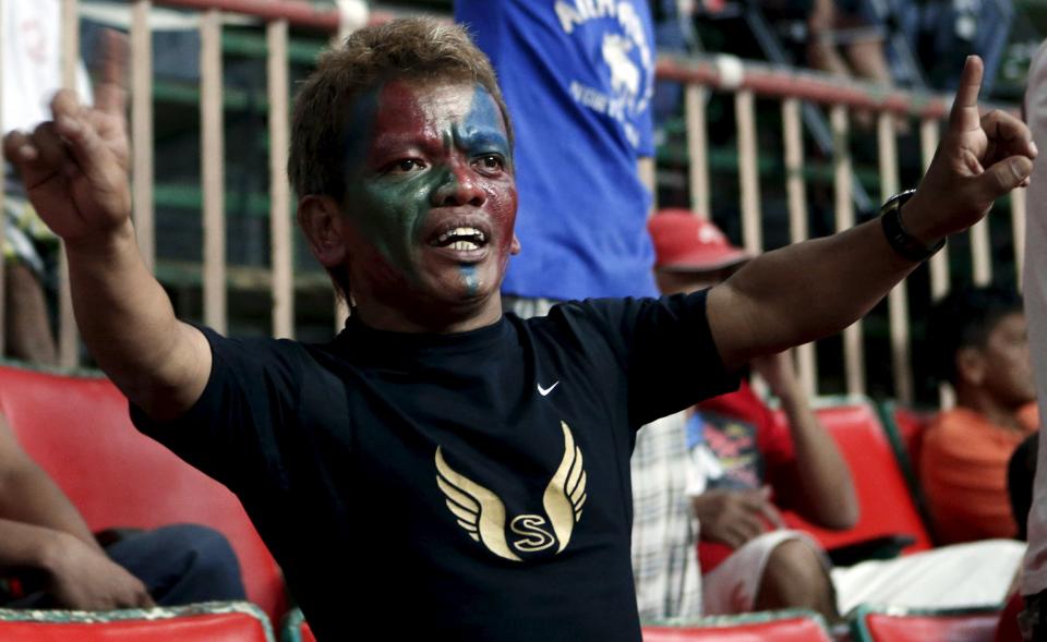 Kristo, a bet caller, shouts at gamblers at a cockfighting arena in Angeles city, north of Manila, Philippines, March 11, 2015. Cockfighting has a long history in the Philippines, dating back years prior to the country's Spanish colonisation in 1521. When paying your final respects for a relative or friend, the last thing you might expect to see at the wake is people placing bets on a card game or bingo. Not in the Philippines. Filipinos, like many Asians, love their gambling. But making wagers on games such as "sakla", the local version of Spanish tarot cards, is particularly common at wakes because the family of the deceased gets a share of the winnings to help cover funeral expenses. Authorities have sought to regulate betting but illegal games persist, with men and women, rich and poor, betting on anything from cockfighting to the Basque hard-rubber ball game of jai-alai, basketball to spider races. Many told Reuters photographer Erik De Castro that gambling is only an entertaining diversion in a country where two-fifths of the population live on $2 a day. But he found that some gamble every day. Casino security personnel told of customers begging to be banned from the premises, while a financier who lends gamblers money at high interest described the dozens of vehicles and wads of land titles given as collateral by those hoping lady luck would bring them riches. REUTERS/Erik De Castro PICTURE 5 OF 29 FOR WIDER IMAGE STORY "HIGH STAKES IN MANILA". SEARCH "BINGO ERIK" FOR ALL IMAGES.