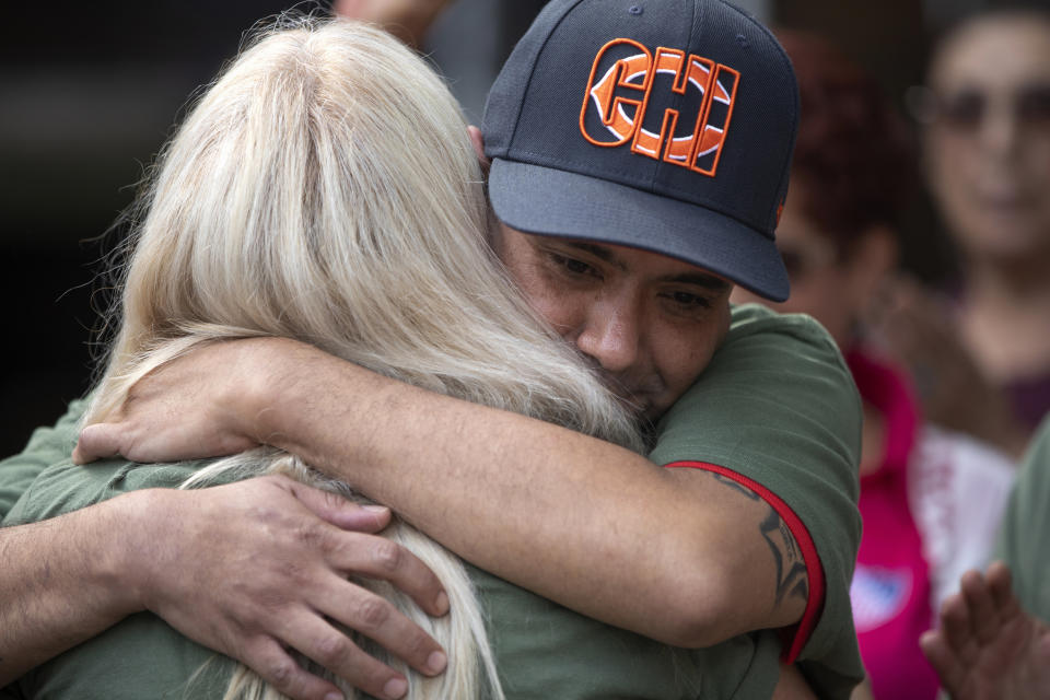 United States Army veteran Miguel Perez Jr. is greeted by friends and family at a news conference Tuesday, Sept. 24, 2019, at Lincoln Methodist Church in Chicago. Perez, an Army veteran who was deported to Mexico in 2018, arrived back in Chicago Tuesday for a final chance at becoming a U.S. citizen and living in the city he has called home since boyhood. (Erin Hooley/Chicago Tribune via AP)