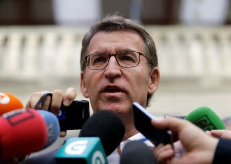 Galician President and member of the People's Party (PP) Alberto Nunez Feijoo talks to reporters outside a polling station after voting in Galician regional elections in Vigo, northern Spain, September 25, 2016. REUTERS/Miguel Vidal