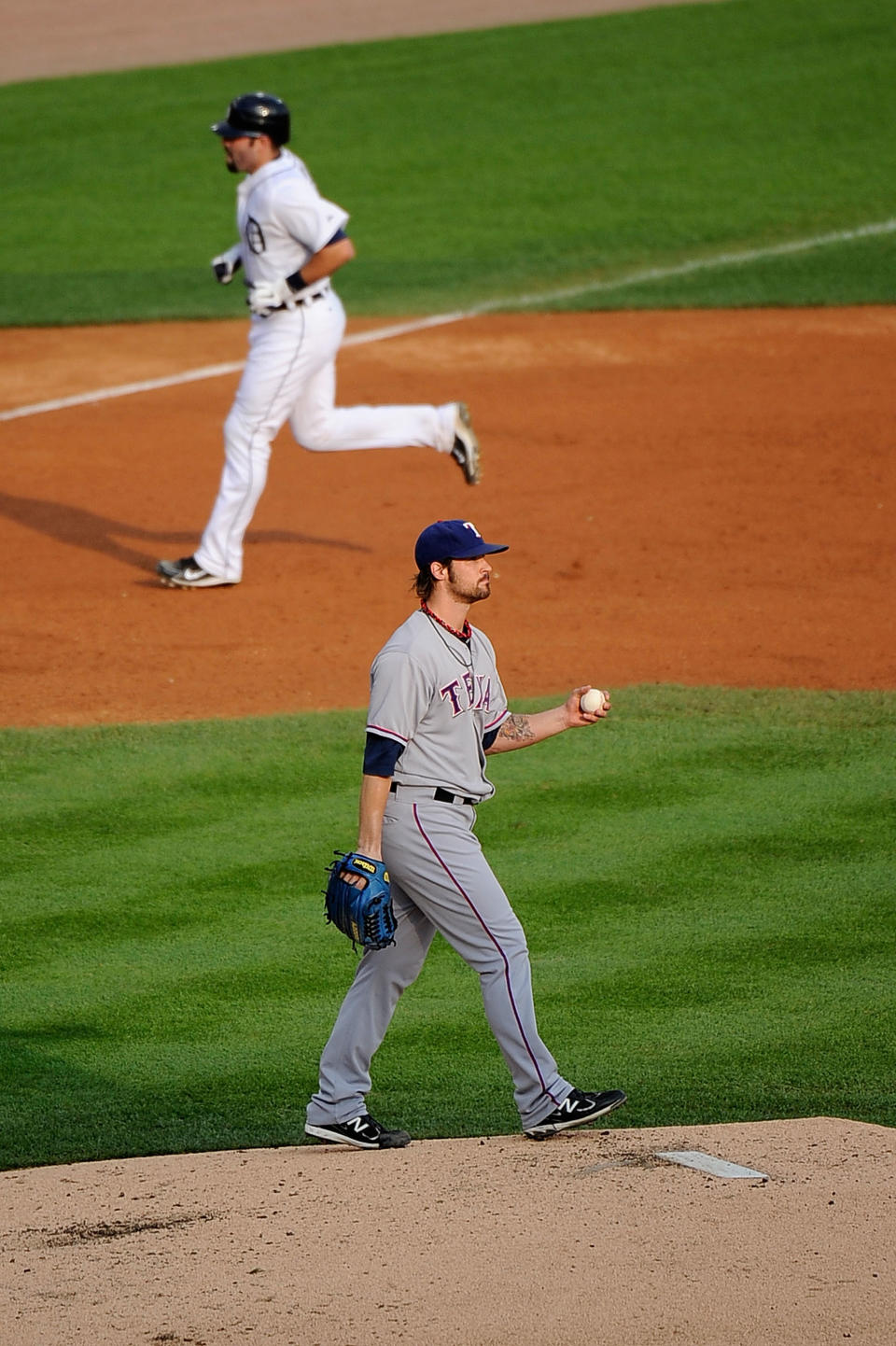 DETROIT, MI - OCTOBER 13: C.J. Wilson #36 of the Texas Rangers stands on the mound as Alex Avila #13 of the Detroit Tigers runs the bases after hitting a solo home run in the third inning of Game Five of the American League Championship Series at Comerica Park on October 13, 2011 in Detroit, Michigan. (Photo by Kevork Djansezian/Getty Images)