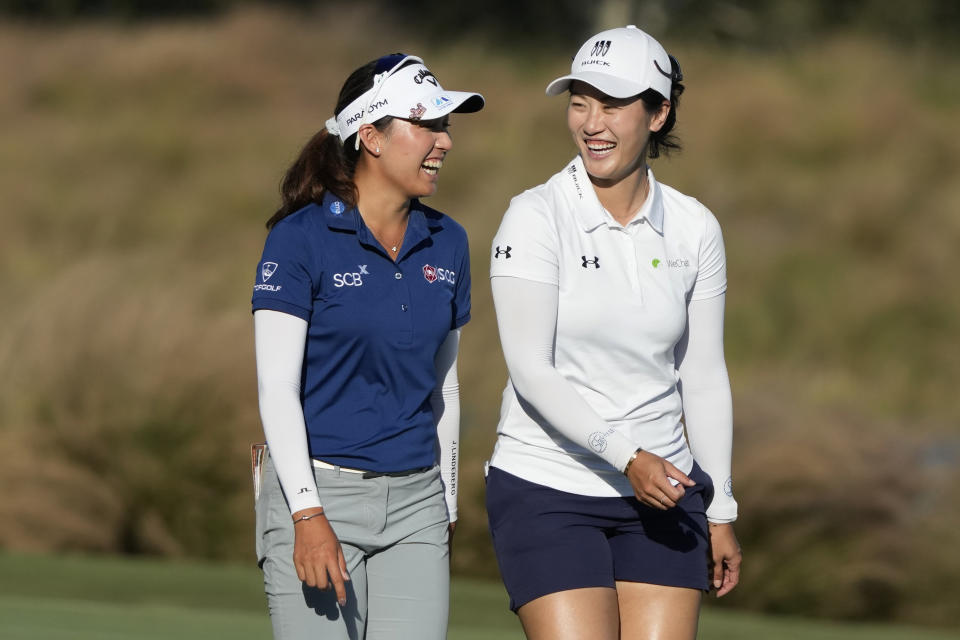 Atthaya Thitikul, left, of Thailand, and Xiyu Lin, right, of China, walk on the 18th fairway during the second round of the LPGA CME Group Tour Championship golf tournament, Friday, Nov. 17, 2023, in Naples, Fla. (AP Photo/Lynne Sladky)