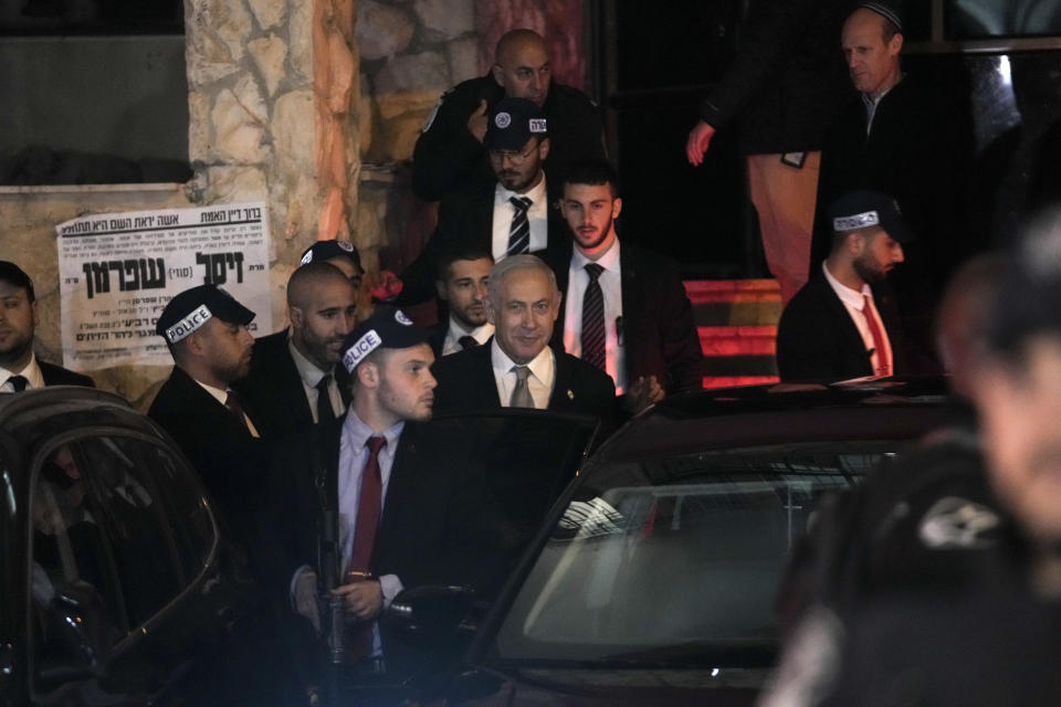 Israeli Prime Minister Benjamin Netanyahu enters his car after visited his ally Aryeh Deri, a Cabinet minister and the head of the ultra-Orthodox Shas party, In Jerusalem, Wednesday, Jan. 18, 2023. Israel's Supreme Court ruled Wednesday that Netanyahu must fire Deri, presenting the Israeli leader with a potential coalition crisis and deepening a rift over the power of the courts. The high court ruled that Deri is disqualified from serving as a minister after he was convicted last year for tax offenses and placed on probation as part of a plea deal. (AP Photo/Mahmoud Illean)