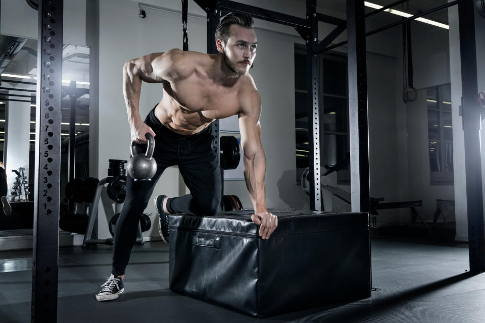 A man performing a kettlebell single-arm bent-over row