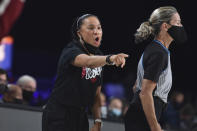 In this photo provided by Bahamas Visual Services, South Carolina head coach Dawn Staley gestures during an NCAA college basketball game against UConn at Paradise Island, Bahamas, Monday, Nov. 22, 2021. No. 1 South Carolina defeated No. 2 UConn 73-57. The official at right is unidentified. (Donald Knowles/Bahamas Visual Services via AP)