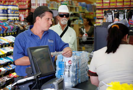 A shopper waits to purchase water in Sedano's Supermarket in the Little Havana neighborhood in Miami, Florida, September 5, 2017. REUTERS/Joe Skipper