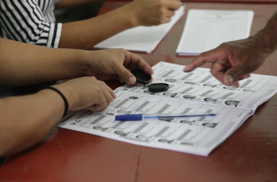 A man puts his fingerprint after voting during congressional elections in Lima, Peru, Sunday, Jan. 26, 2020. Peruvians are voting to elect 130 new members of the congress that will legislate for only one year in place of the congress that was dissolved by president Martin Vizacarra in September 2019. (AP Photo/Martin Mejia)