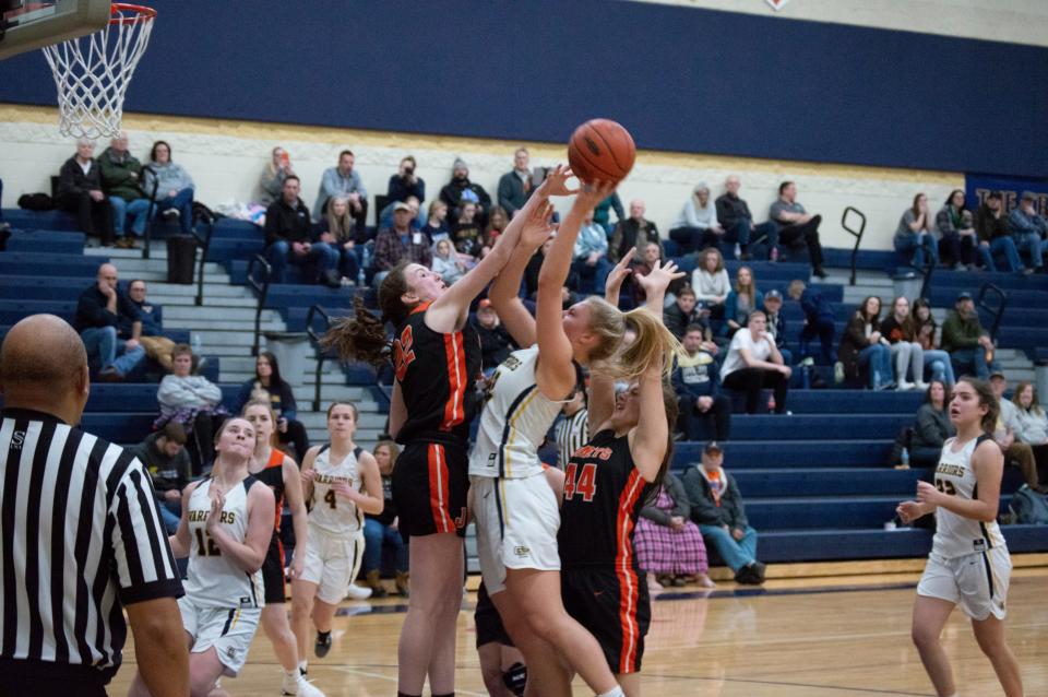 Senior Comet Natalie Doyle (22) attempts to block a Grass Lake scoring attempt.