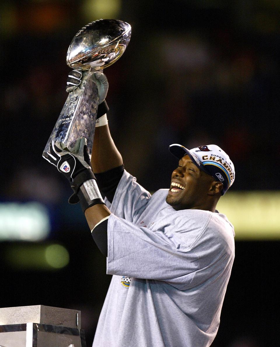 (NYT53) SAN DIEGO, Calif. -- Jan. 26, 2003 -- FBN-SUPER-BOWL-23 -- Tampa Bay Buccaneers' safety Dexter Jackson, who was selected as the Most Valuable Player of Super Bowl XXXVII, holds the Vince Lombardi trophy after his team defeated the Oakland Raiders 48-21 in San Diego, January 26, 2003. Jackson intercepted two passes in the victory, the Bucs' first-ever Super Bowl win. The win was the Bucs first championship ever. (Vincent Laforet/The New York Times)