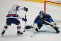 Kazakhstan's goalkeeper Nikita Boyarkin, right, makes a save in front of Unted States' Brock Nelson during the preliminary round match between United States and Kazakhstan at the Ice Hockey World Championships in Ostrava, Czech Republic, Sunday, May 19, 2024. (AP Photo/Darko Vojinovic)