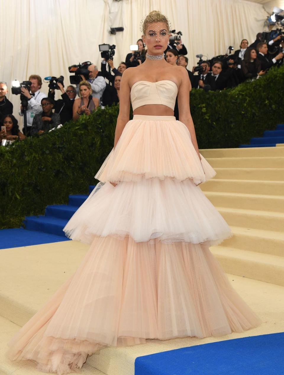 <p>Hailey Baldwin<span class="redactor-invisible-space"> wore a Carolina Herrera crop top and matching tiered tulle skirt to attend the 2017 Met Gala.</span></p>