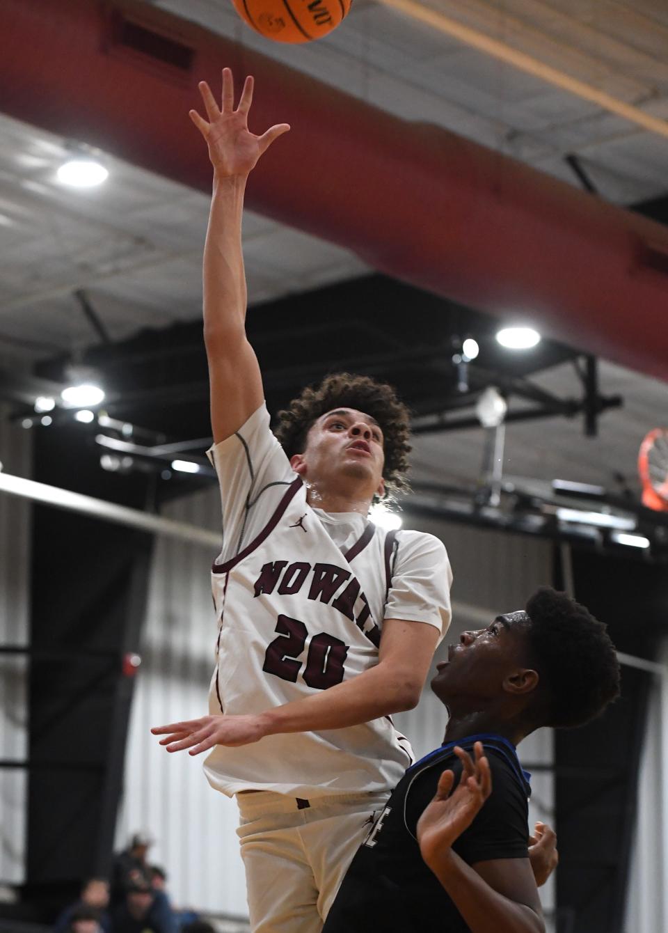 Nowata High School's Talon Thompson (20) takes a shot during basketball action at the Ty Hewitt Memorial Tournament in Nowata on Dec. 4, 2023. The Ironmen fell to Rejoice Christian, 77-49.
