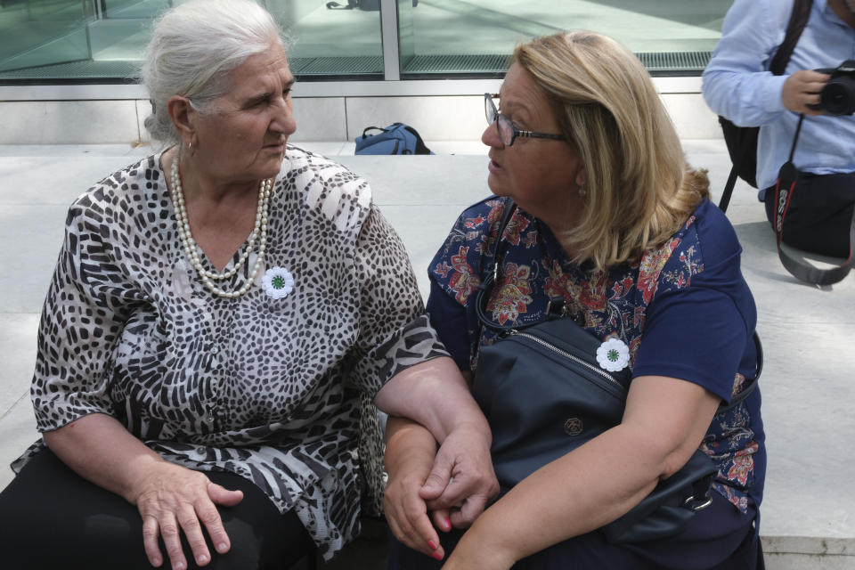 Munira Subasic, left, and Nermina Lakota, of the Mothers of Srebrenica organization, sit outside the Dutch Supreme Court, in The Hague, on Friday July 19, 2019, after the court issued a ruling in their case against the Dutch state. The Dutch Supreme Court has upheld a lower court’s ruling that the Netherlands is partially liable in the deaths of some 350 Muslim men who were murdered by Bosnian Serb forces during the 1995 Srebrenica massacre. (AP Photo/Michael Corder)