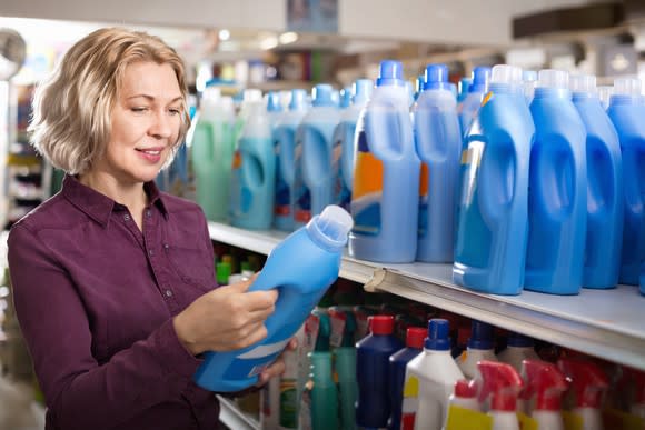 A woman shops for laundry detergent.