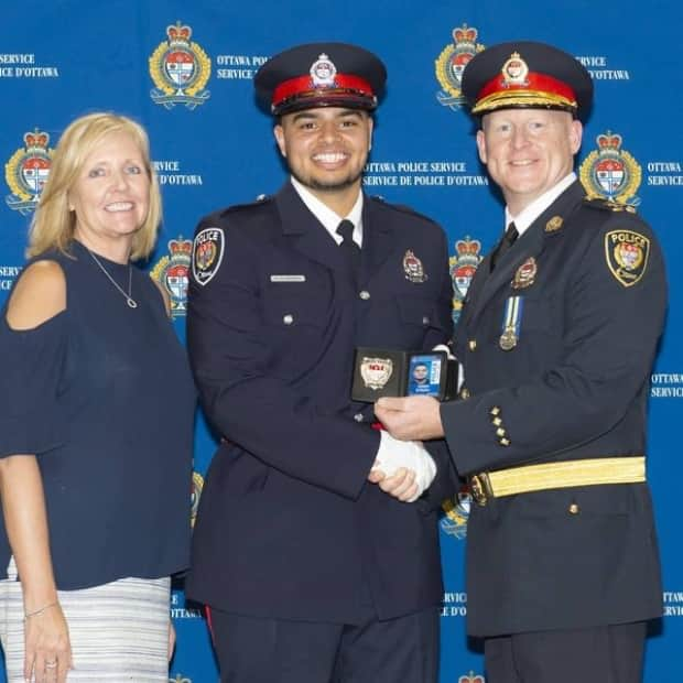 Ottawa police Const. Haidar El Badry, centre, has been charged with corruption-related offences by the RCMP. He was hired in December 2018. (Facebook - image credit)