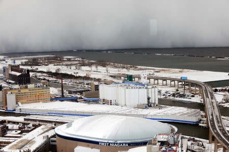 A lake-effect snow storm with freezing temperatures produces a wall of snow travelling over Lake Erie into Buffalo, New York. November 18, 2014. REUTERS/Gary Wiepert