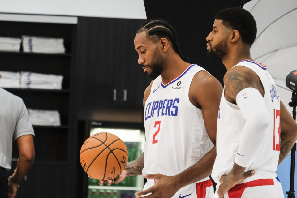 Los Angeles Clippers forwards Kawhi Leonard, left, and Paul George pose for photos during the NBA basketball team's media day in Los Angeles, Sunday, Sept. 29, 2019. (AP Photo/Ringo H.W. Chiu)