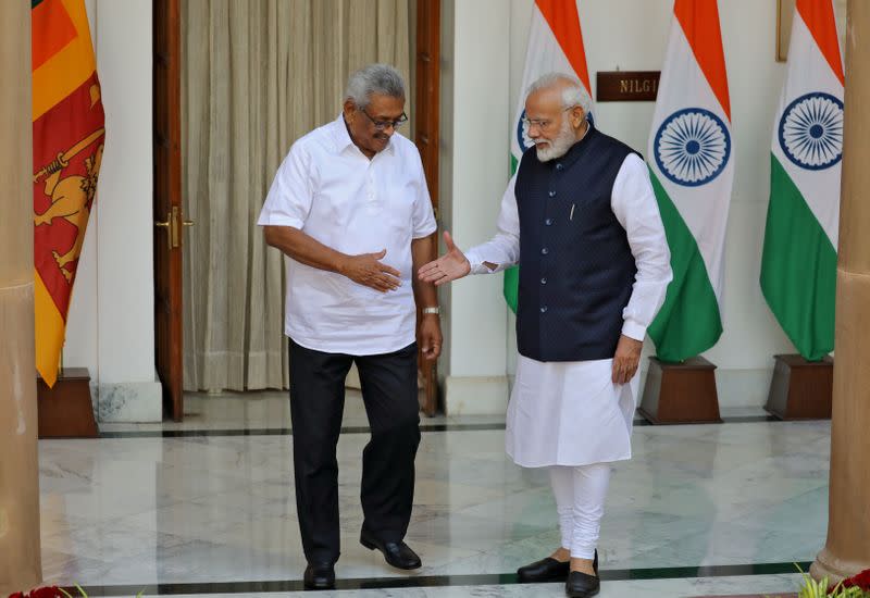 Sri Lanka's President Rajapaksa and India's PM Modi shake their hands during a photo opportunity ahead of their meeting at Hyderabad House in New Delhi