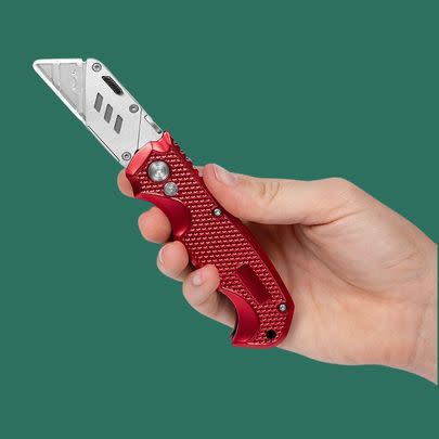 A heavy-duty retractable utility knife with three replacement blades